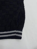Louis Vuitton knit cardigan sleeve with navy ribbing and gray-and-white striped cuff