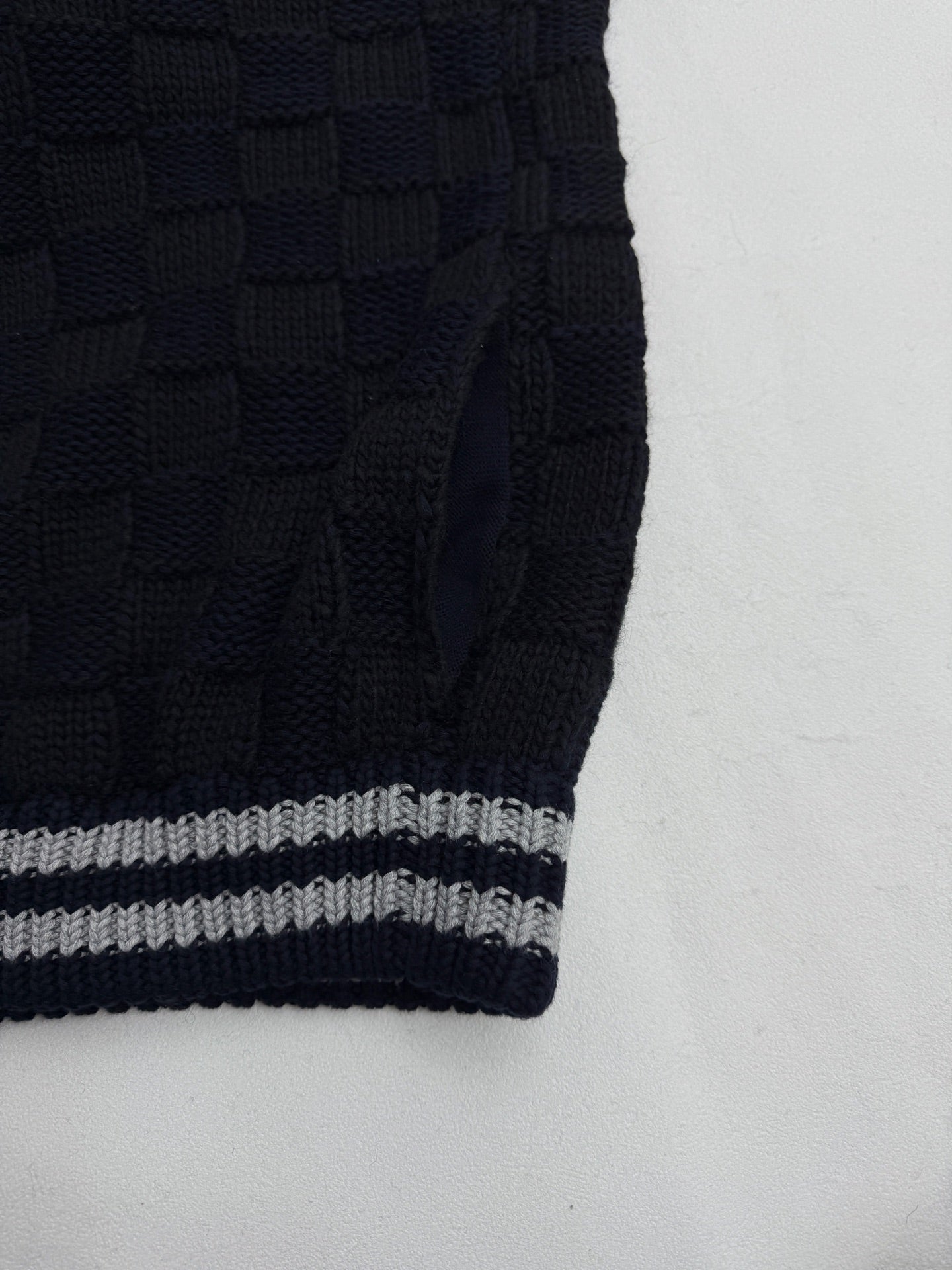 Louis Vuitton knit cardigan sleeve with navy ribbing and gray-and-white striped cuff