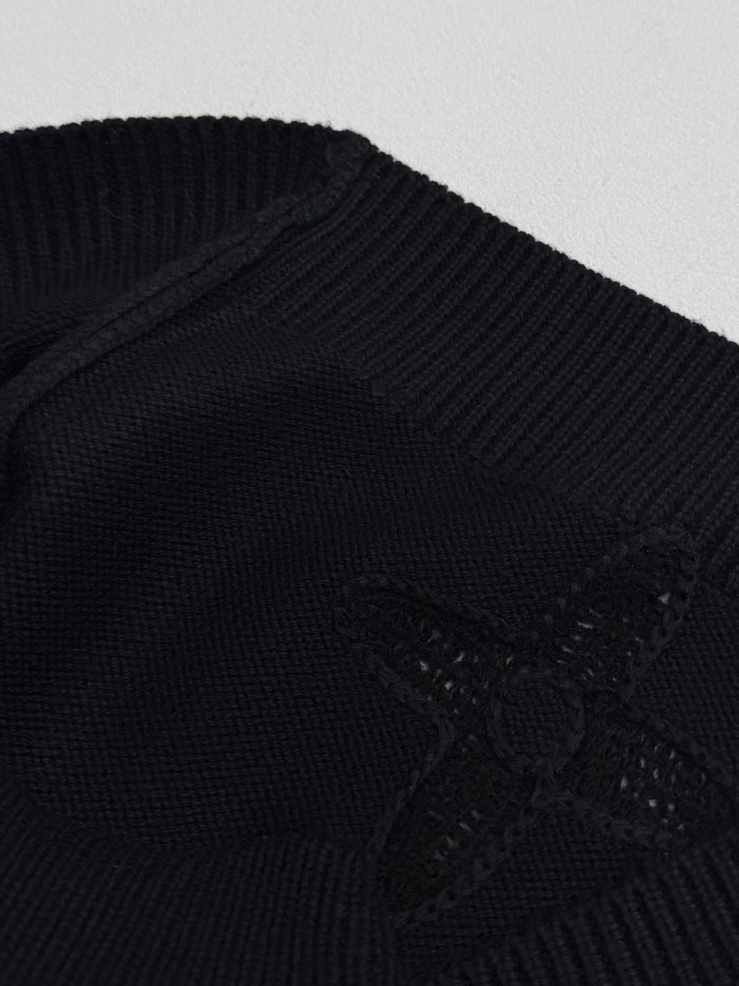 Louis Vuitton sweater knit detail in dark with embossed monogram and textured stitch