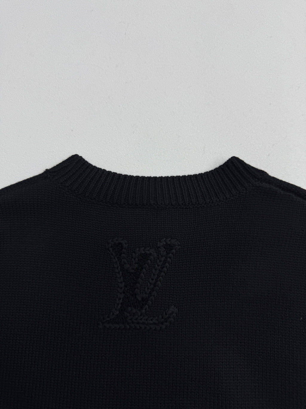 Louis Vuitton sweater back panel in dark knit with large LV monogram crest