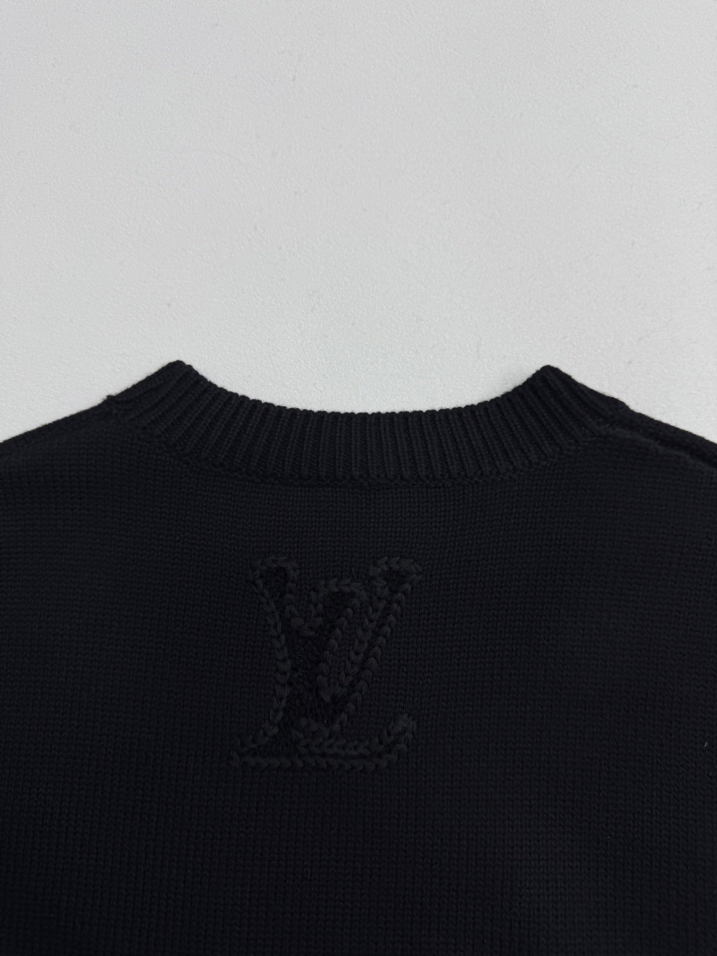 Louis Vuitton sweater back panel in dark knit with large LV monogram crest