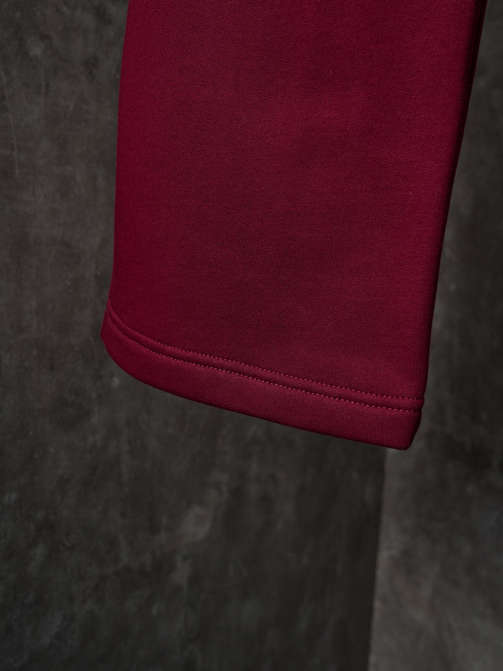 Maroon Gucci sweatpants with cuffed hem and neat stitched edge