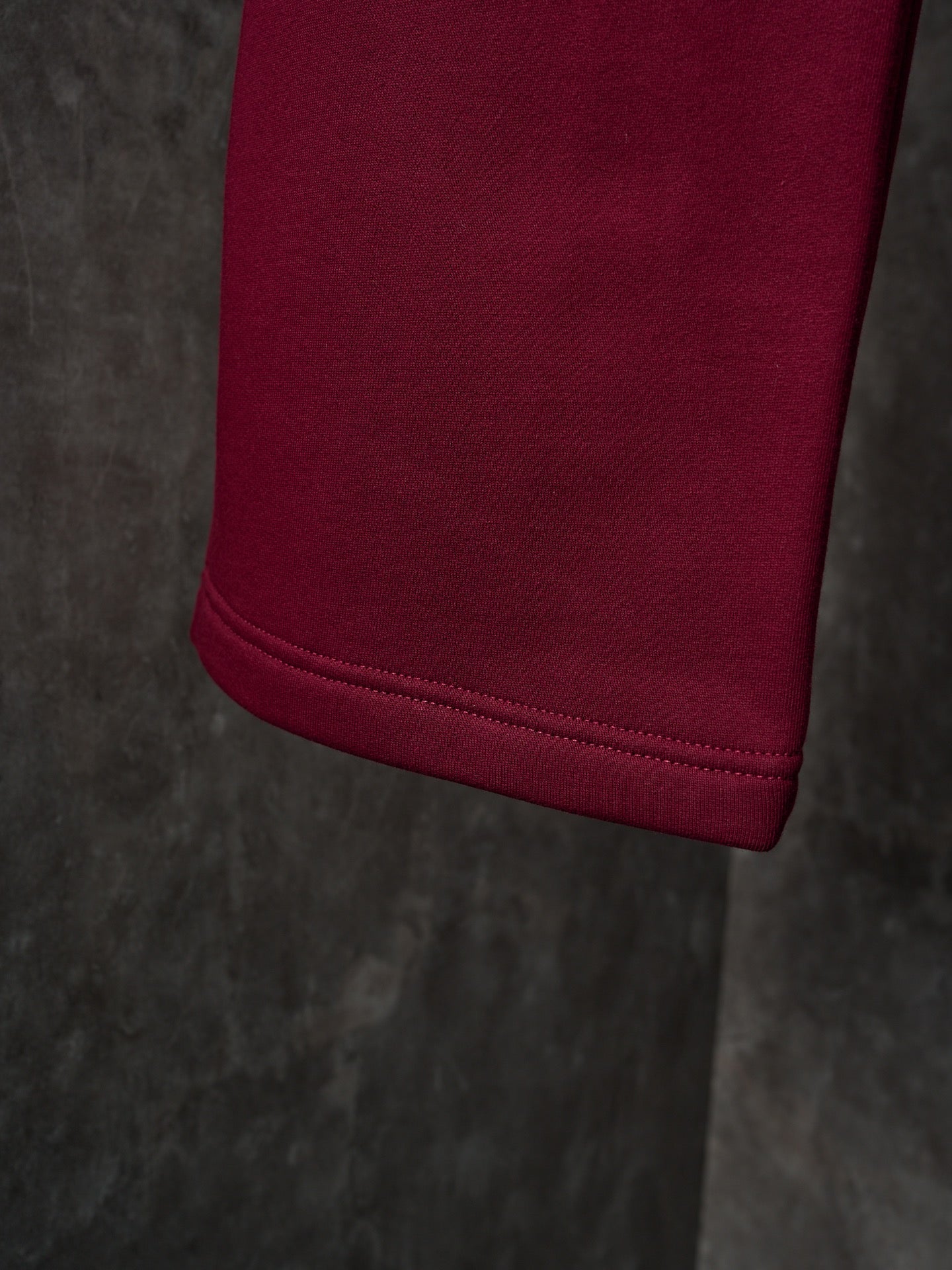 Maroon Gucci sweatpants with cuffed hem and neat stitched edge