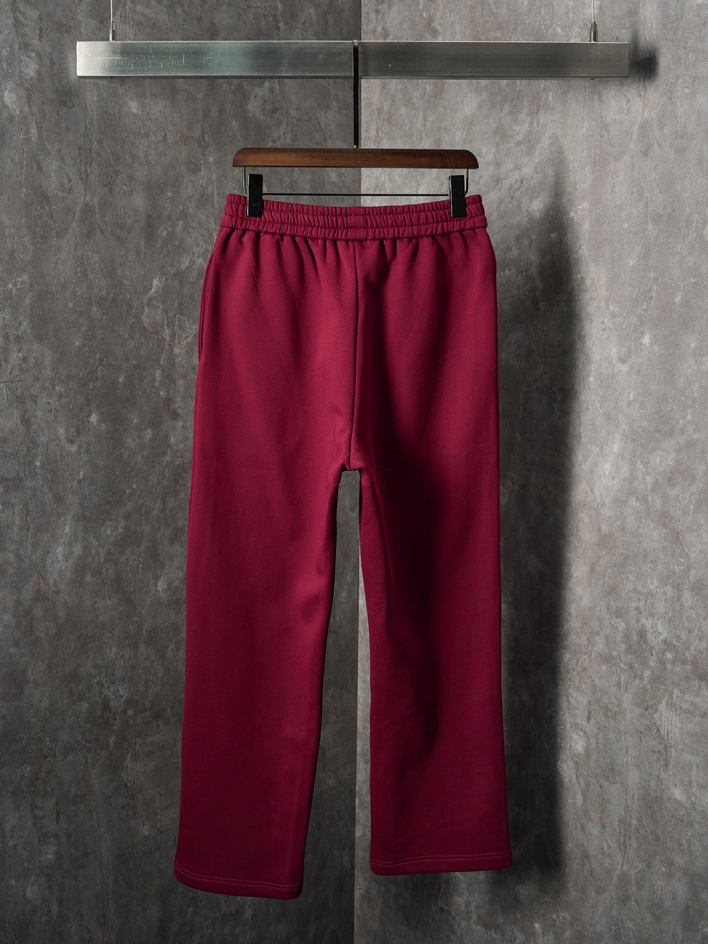 Maroon Gucci sweatpants, front view with cuffed hem and elastic waist