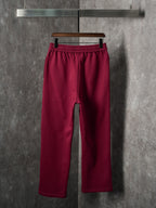 Maroon Gucci sweatpants, front view with cuffed hem and elastic waist