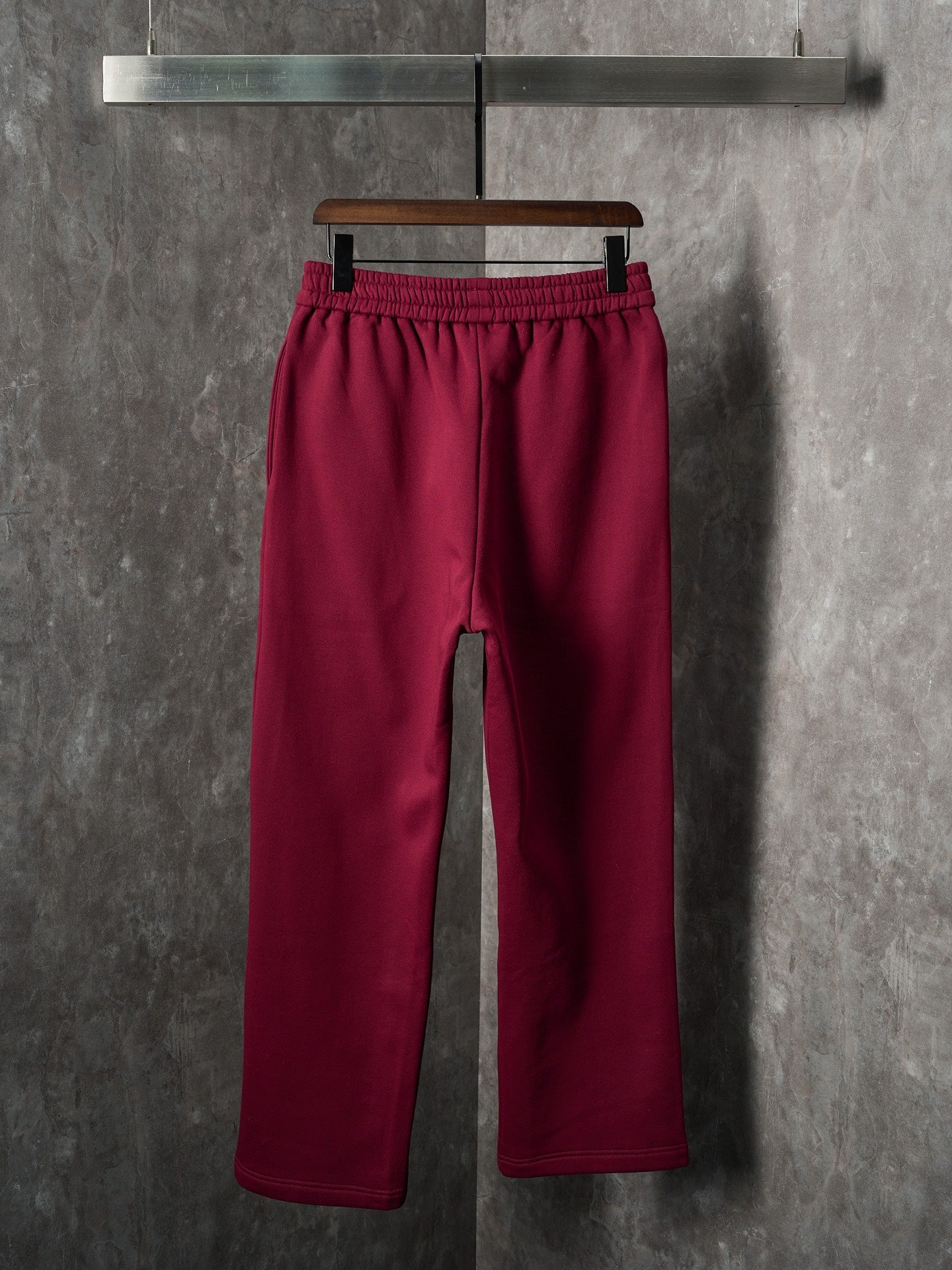 Maroon Gucci sweatpants, front view with cuffed hem and elastic waist