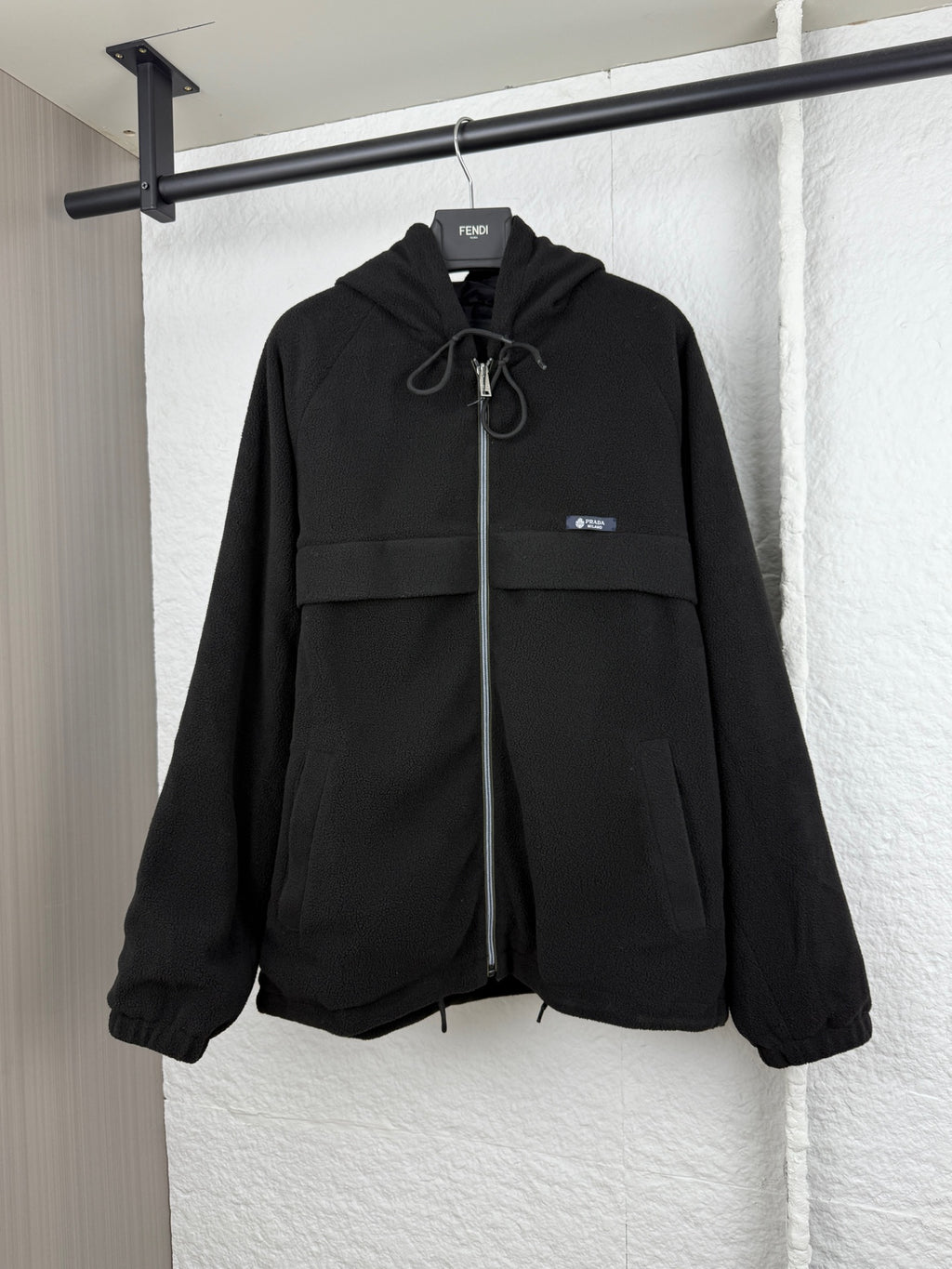 Black hooded jacket with zip front and drawstring neckline