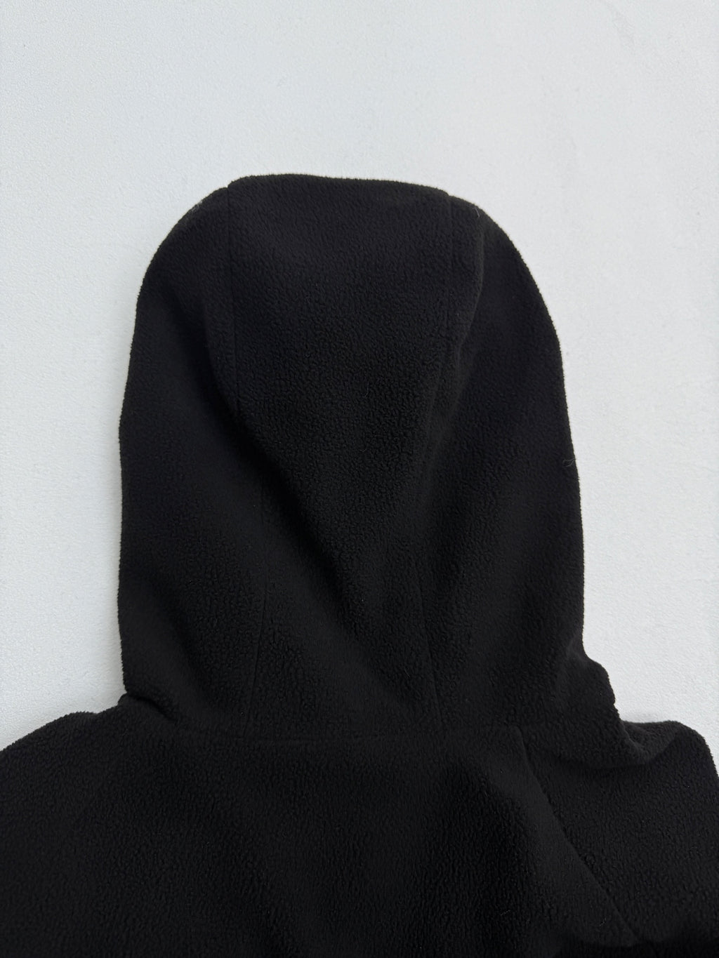 Black hooded jacket shoulder and hood back view