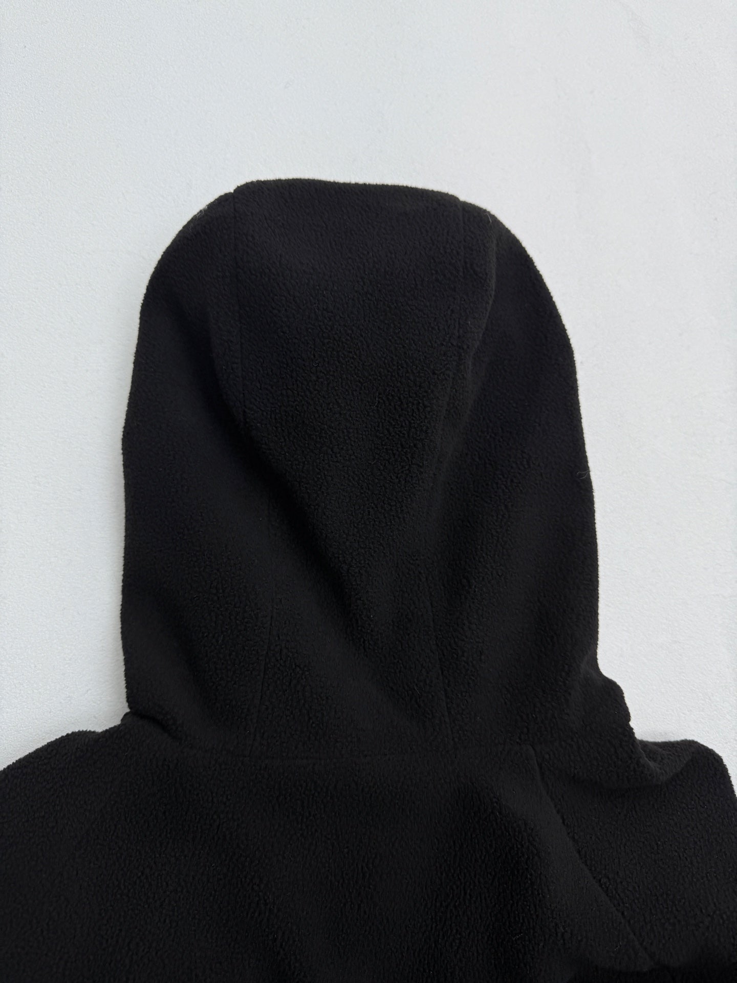 Black hooded jacket shoulder and hood back view