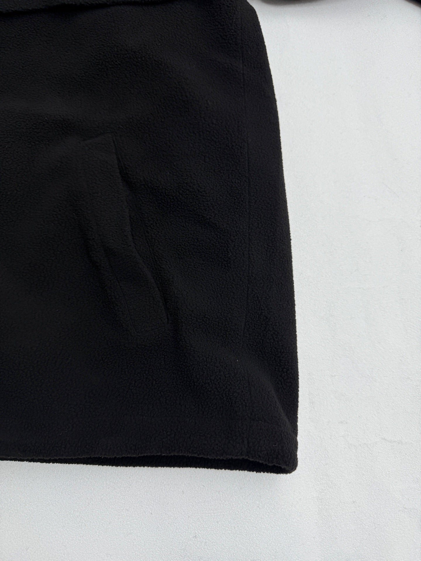 Black hooded jacket hem with seam detail