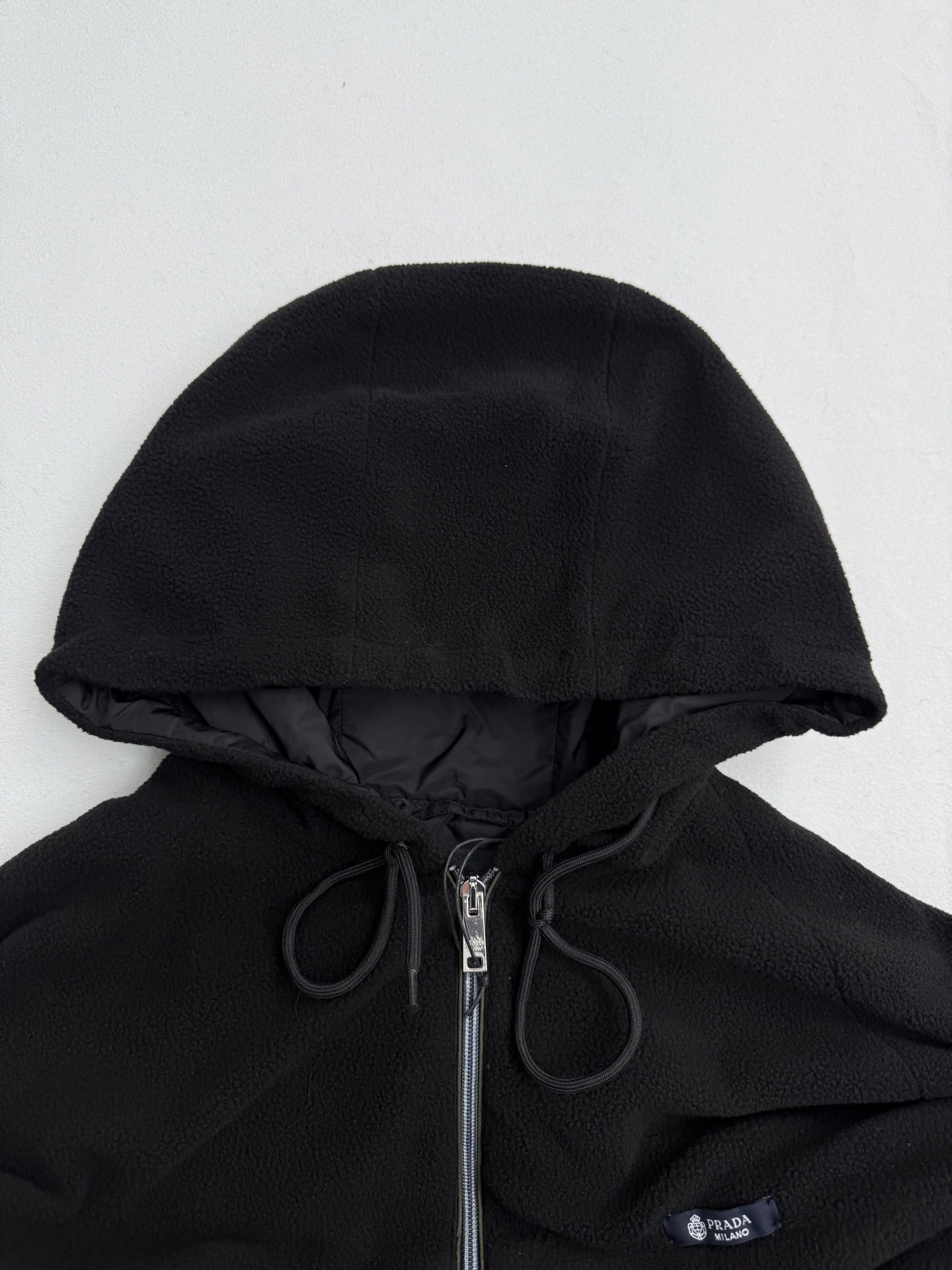 Black hooded jacket with drawstring and PRADA logo badge