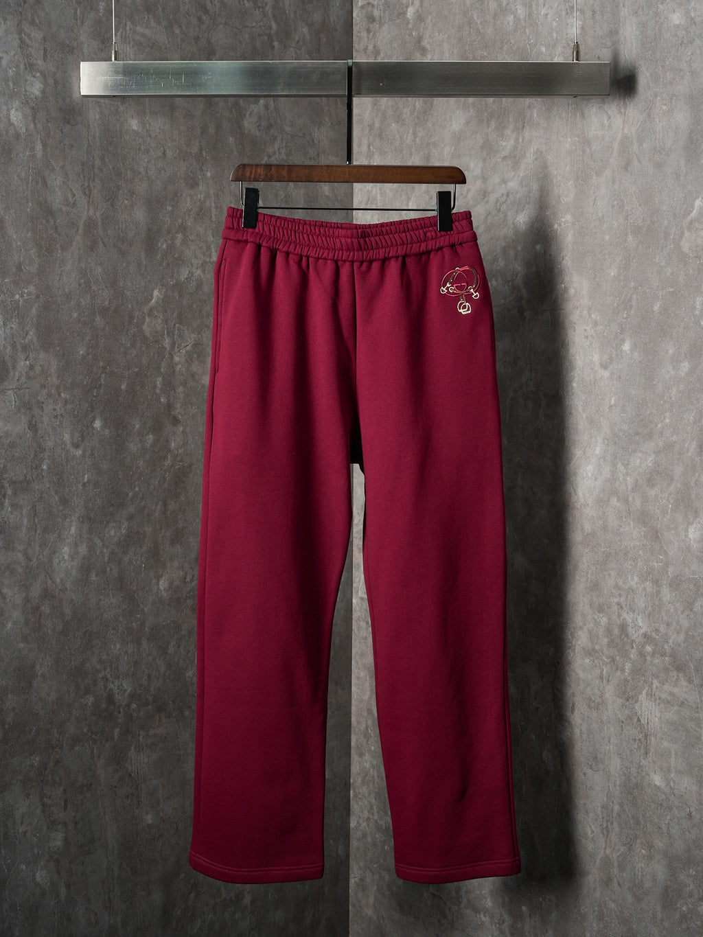 Maroon Gucci sweatpants with elastic waistband and straight wide legs