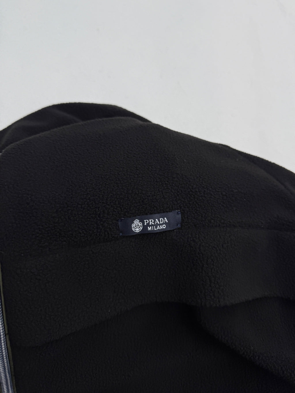 Black jacket hood with PRADA Milano logo patch