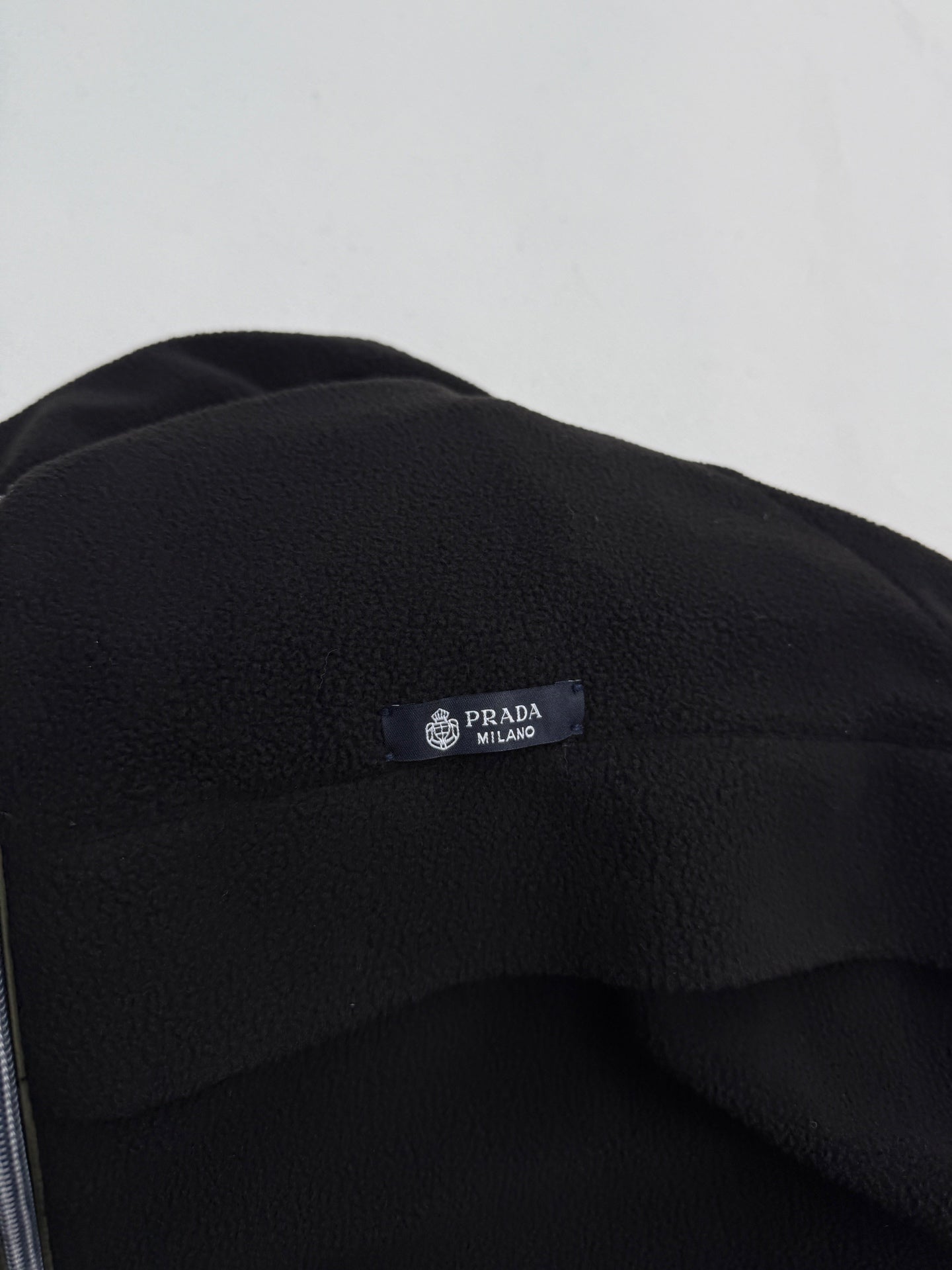 Black jacket hood with PRADA Milano logo patch