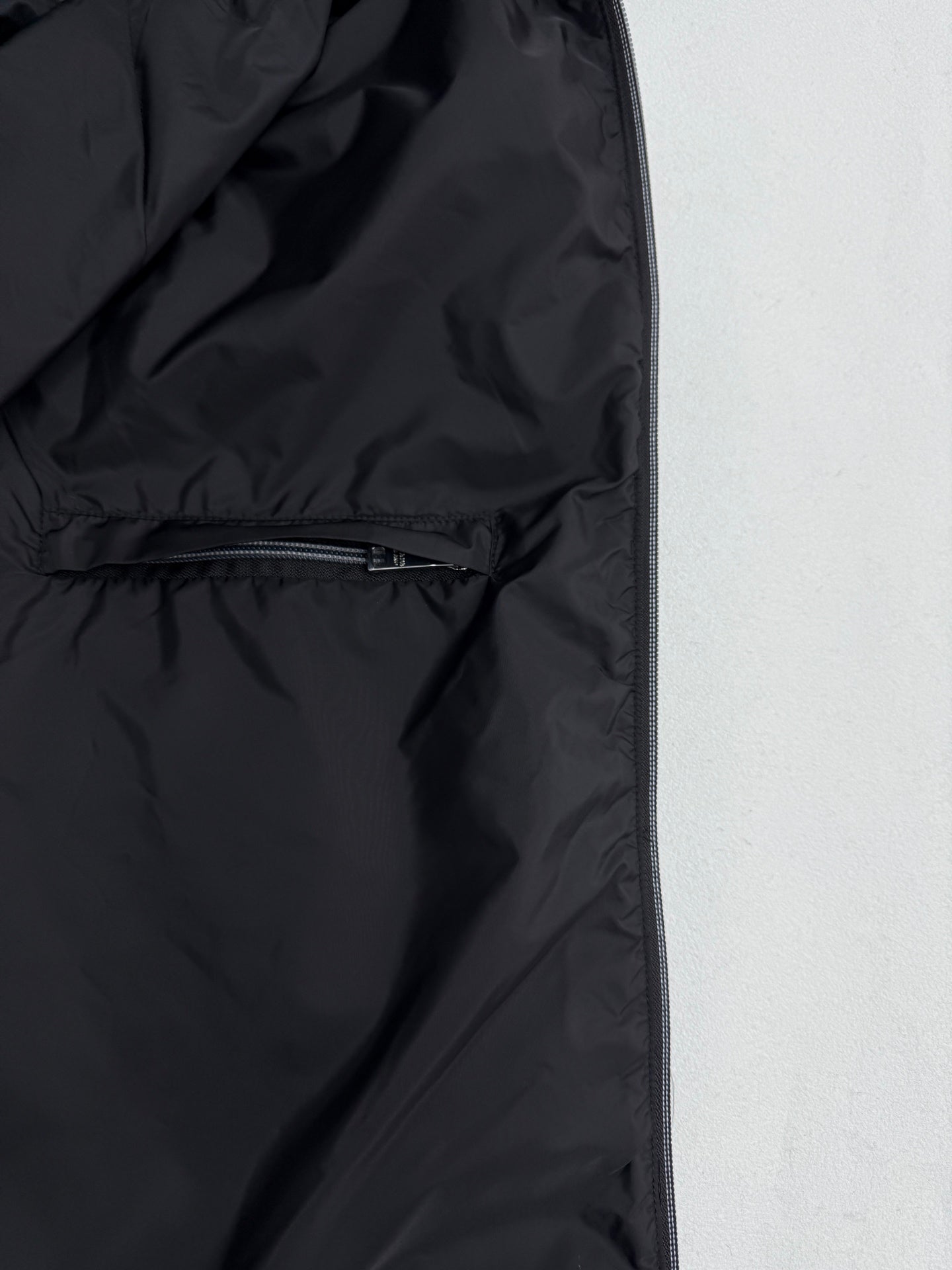 Black nylon jacket lining with zipper and seam stitching