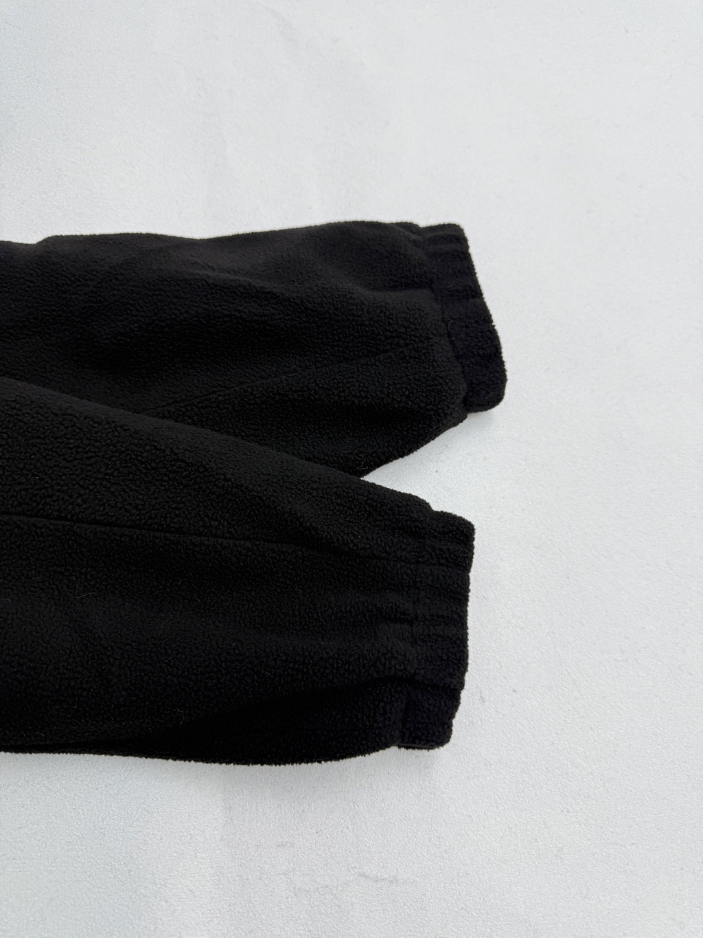Black ribbed cuffs on hooded jacket sleeves