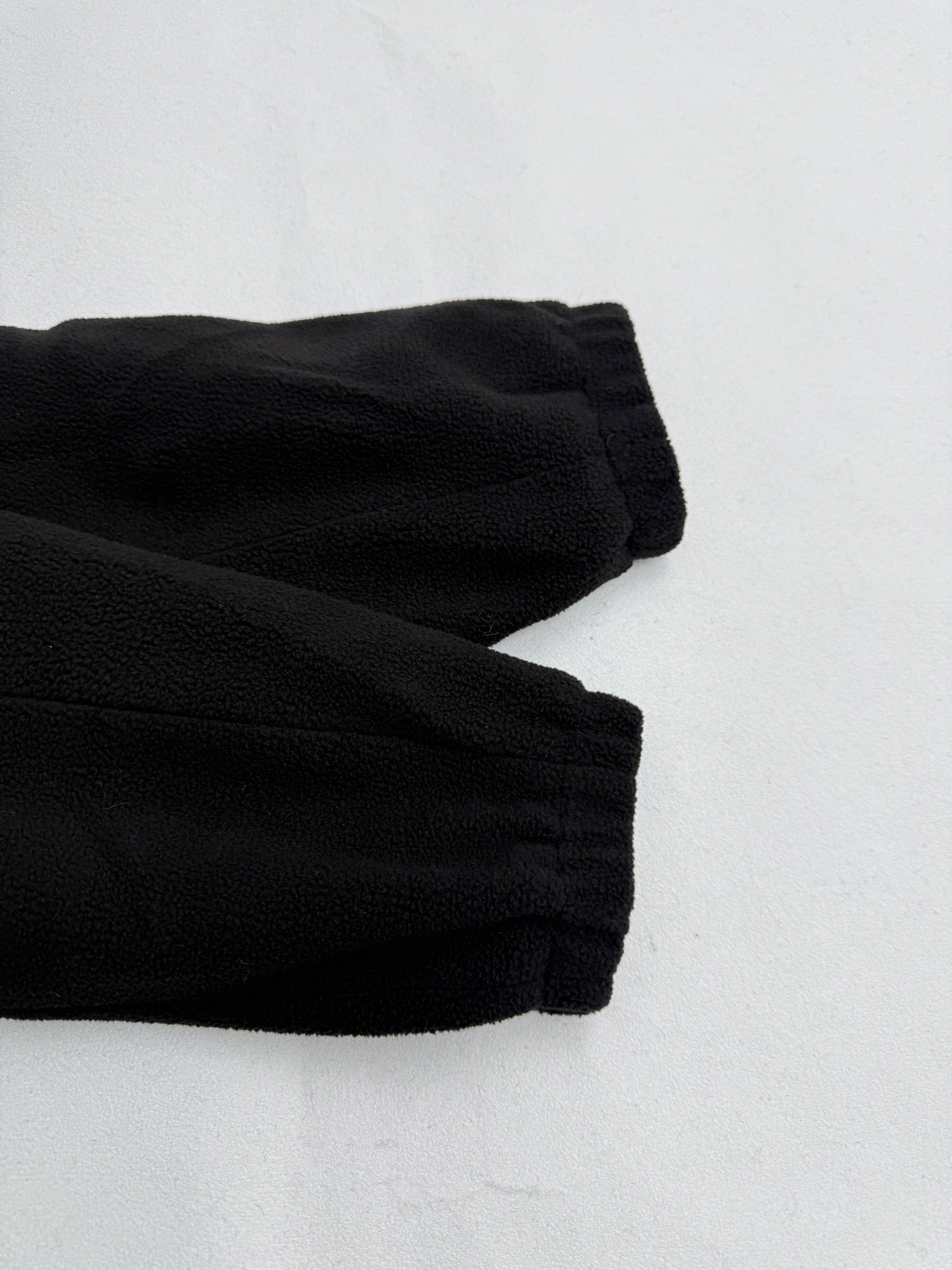 Black ribbed cuffs on hooded jacket sleeves