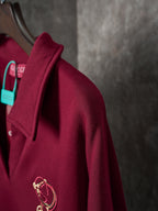 Burgundy polo sweatshirt with collar and gold-tone crest embroidery on chest