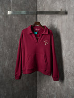 Burgundy long-sleeve polo sweatshirt with embroidered chest logo detail