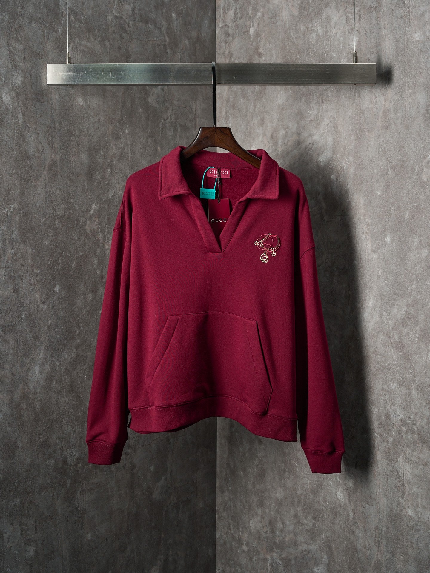 Burgundy long-sleeve polo sweatshirt with embroidered chest logo detail