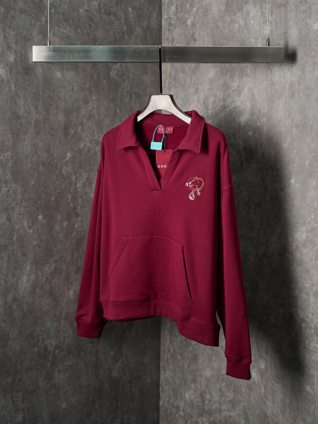 Burgundy long-sleeve polo sweatshirt with embroidered chest logo and collar