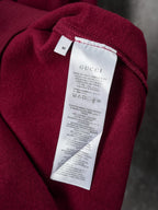 Burgundy polo sweatshirt with white Gucci care label near neckline