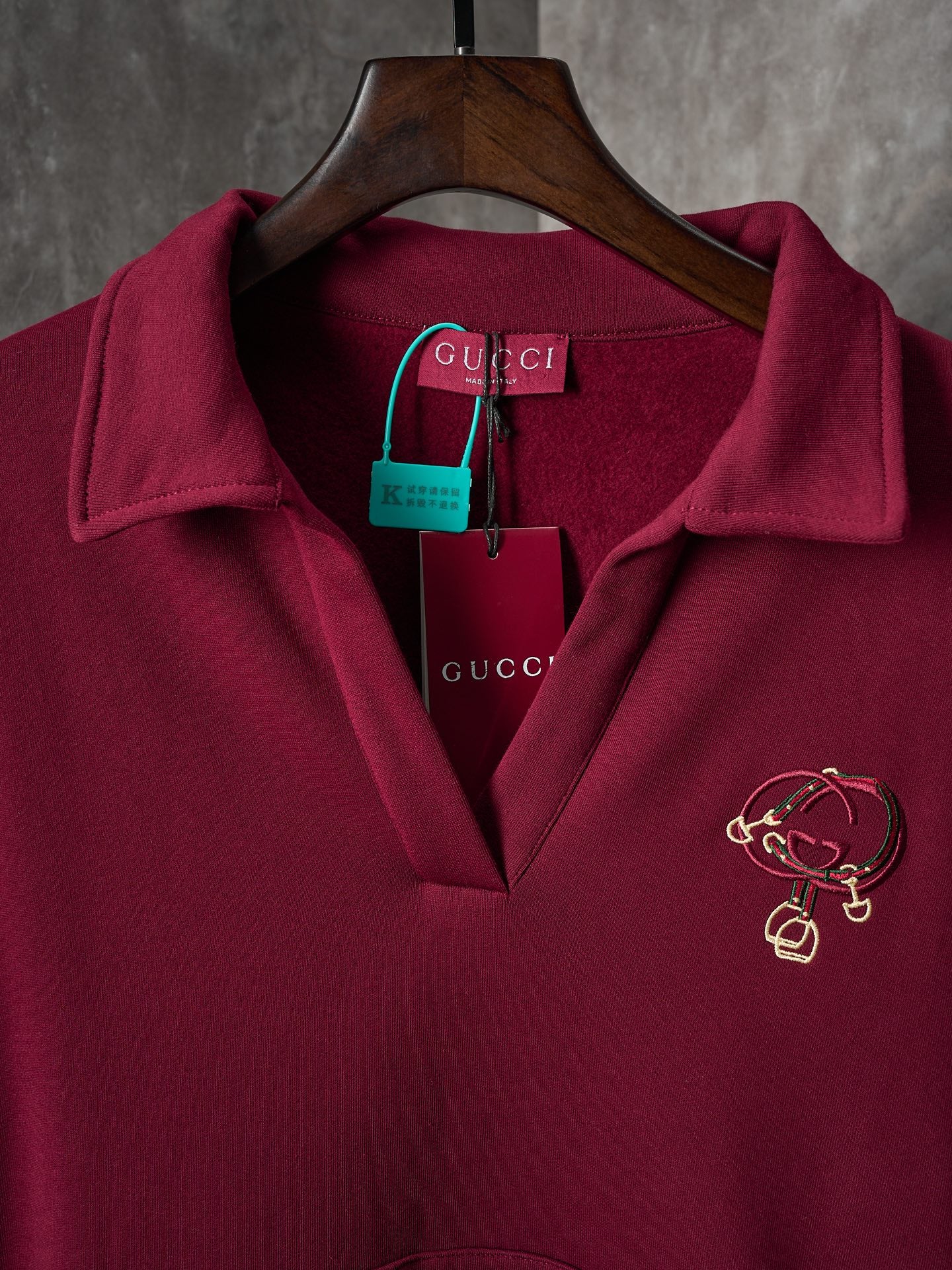 Burgundy polo sweatshirt with embroidered crest logo at chest