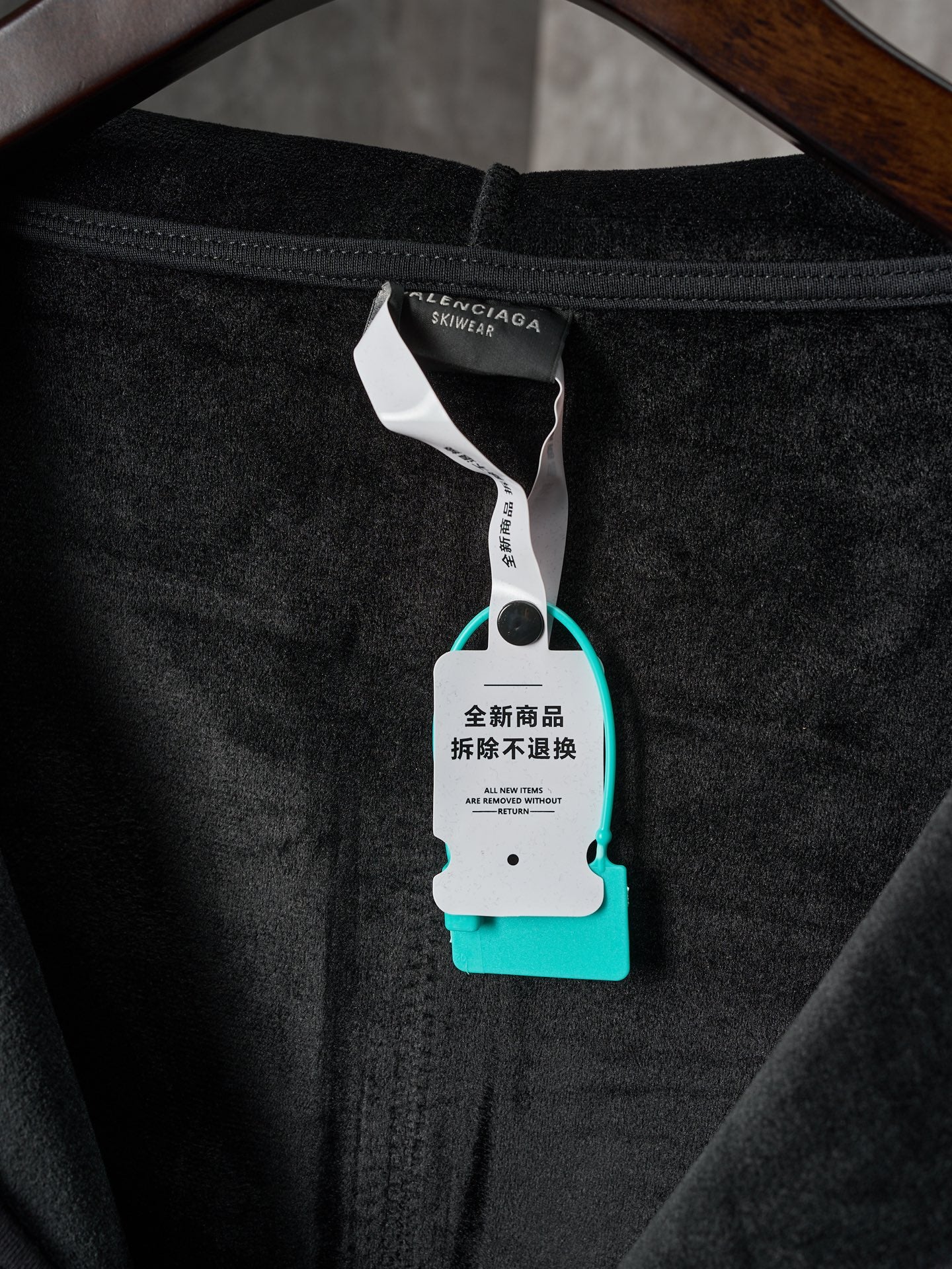 Black Balenciaga hoodie front neckline with care tag on zipper