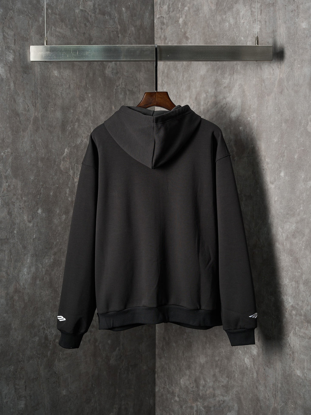 Black Balenciaga pullover hoodie with hood and ribbed cuffs, back view