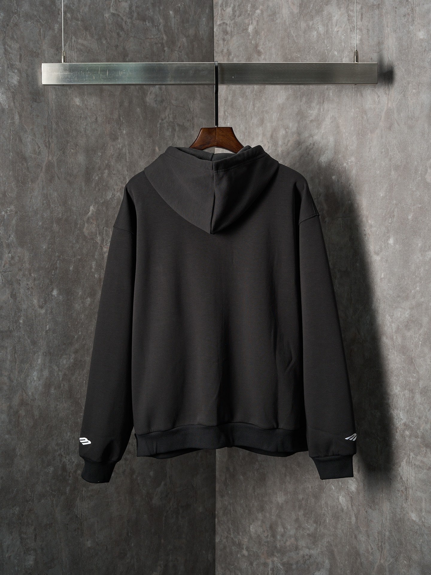 Black Balenciaga pullover hoodie with hood and ribbed cuffs, back view