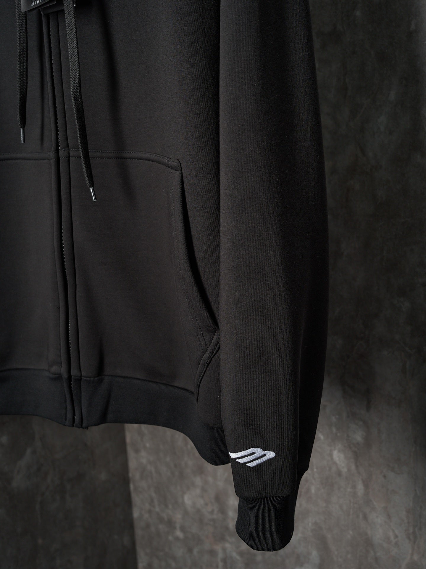 Black Balenciaga hoodie sleeve with small logo patch at cuff