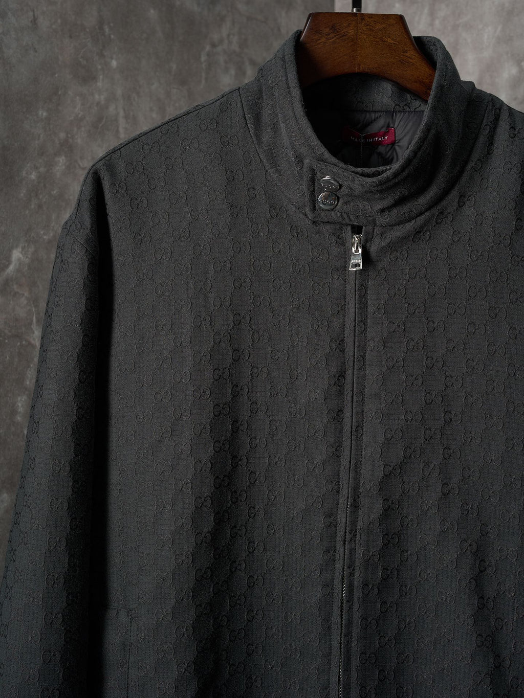 Long jacket front in dark allover GG pattern with stand collar and center zipper