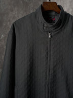 Long jacket front in dark allover GG pattern with stand collar and center zipper