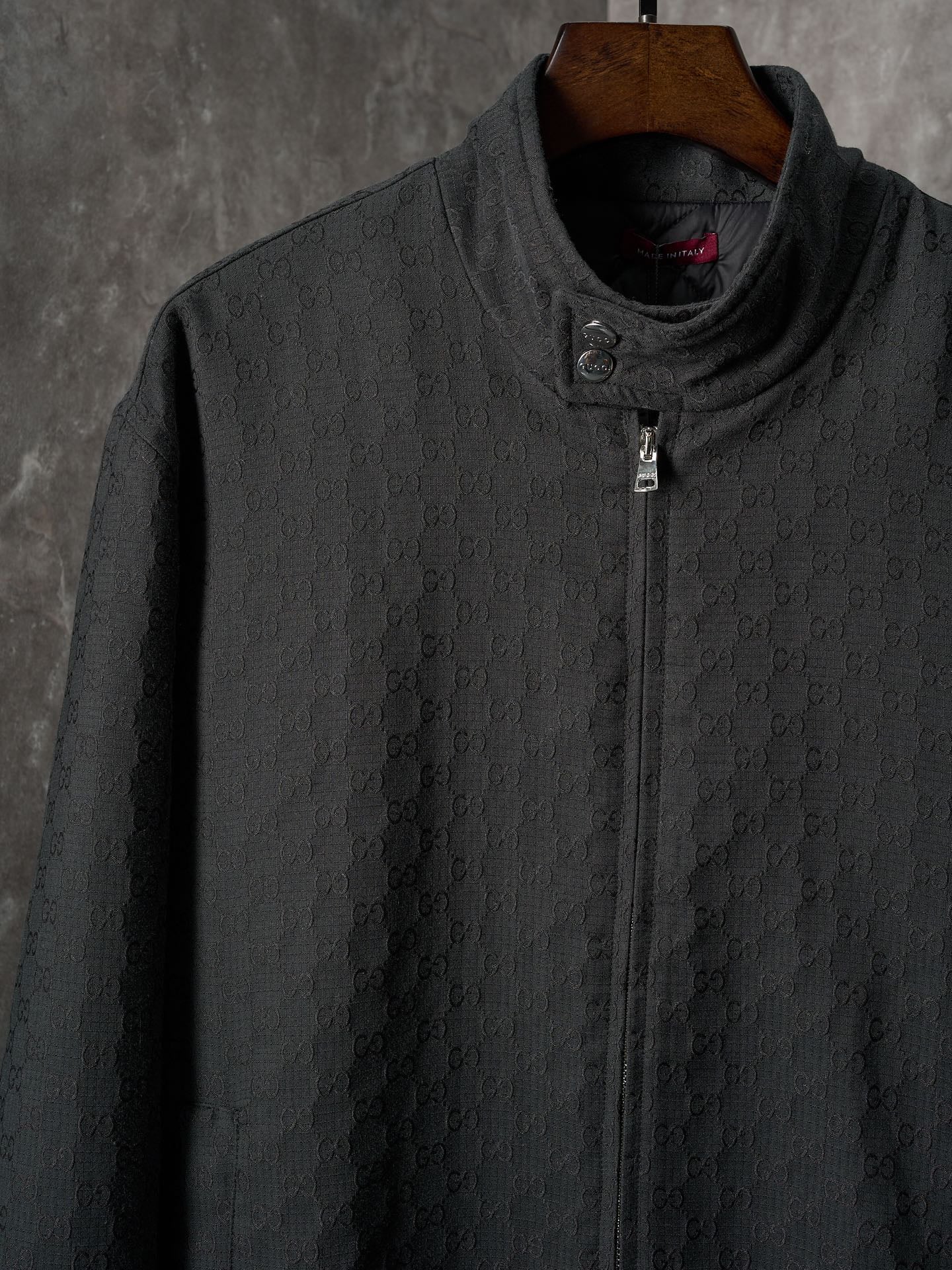 Long jacket front in dark allover GG pattern with stand collar and center zipper