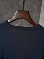 Dark navy knit crewneck sweater neckline with ribbed collar on hanger