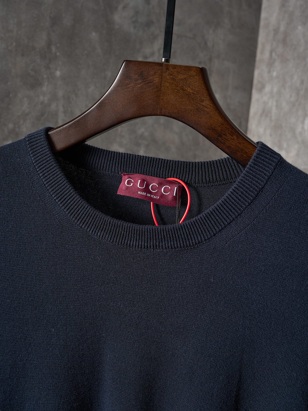Dark navy crewneck sweater neckline with Gucci label inside collar