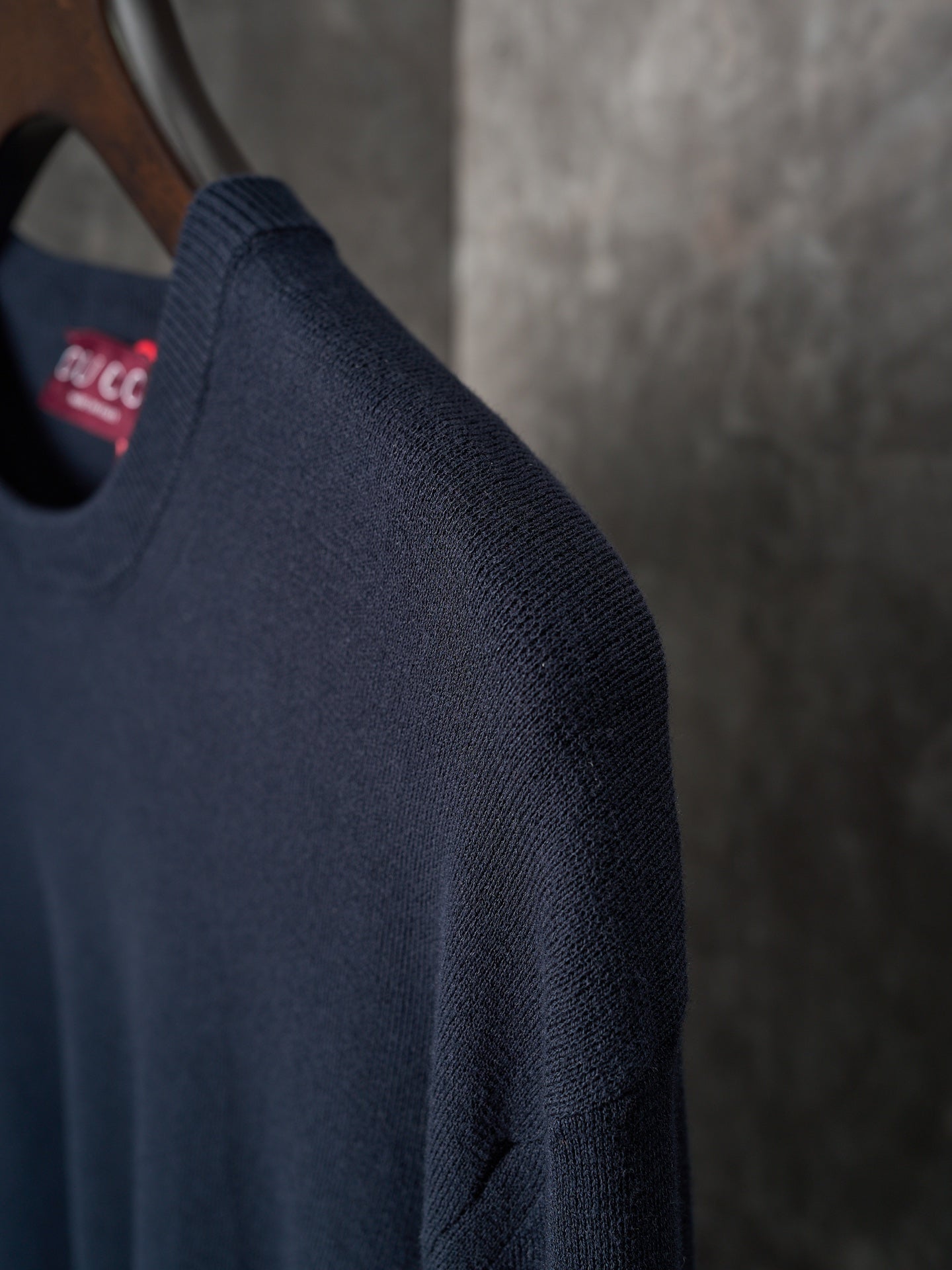 Dark navy knit sweater sleeve with ribbed cuff detail