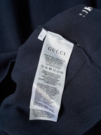 Interior care label on Gucci knit sweater with fabric and washing instructions