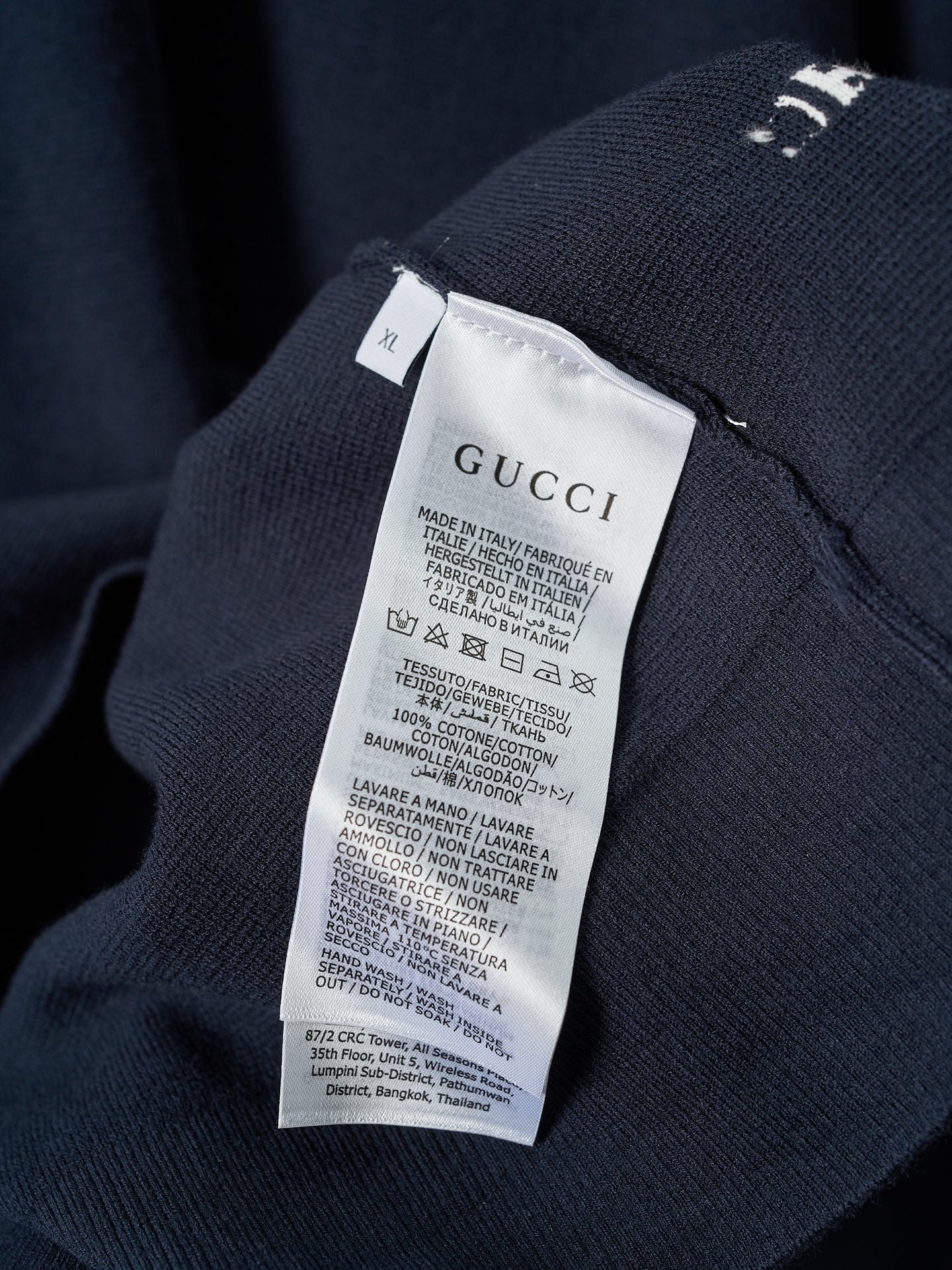 Interior care label on Gucci knit sweater with fabric and washing instructions