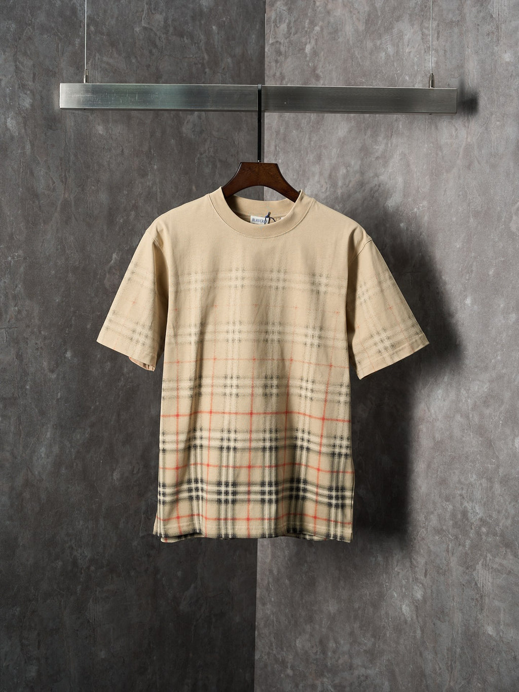 Beige short-sleeve T-shirt with check plaid panel across the lower front