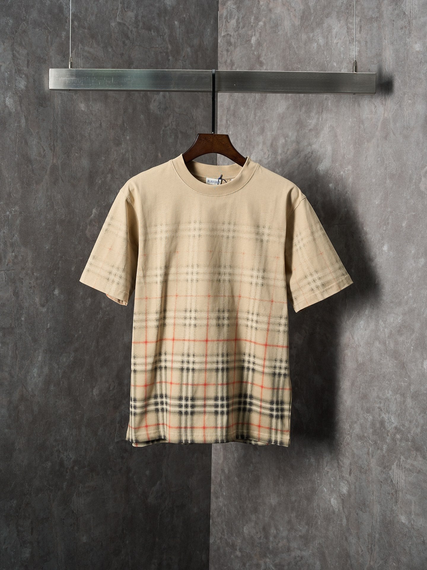 Beige short-sleeve T-shirt with check plaid panel across the lower front