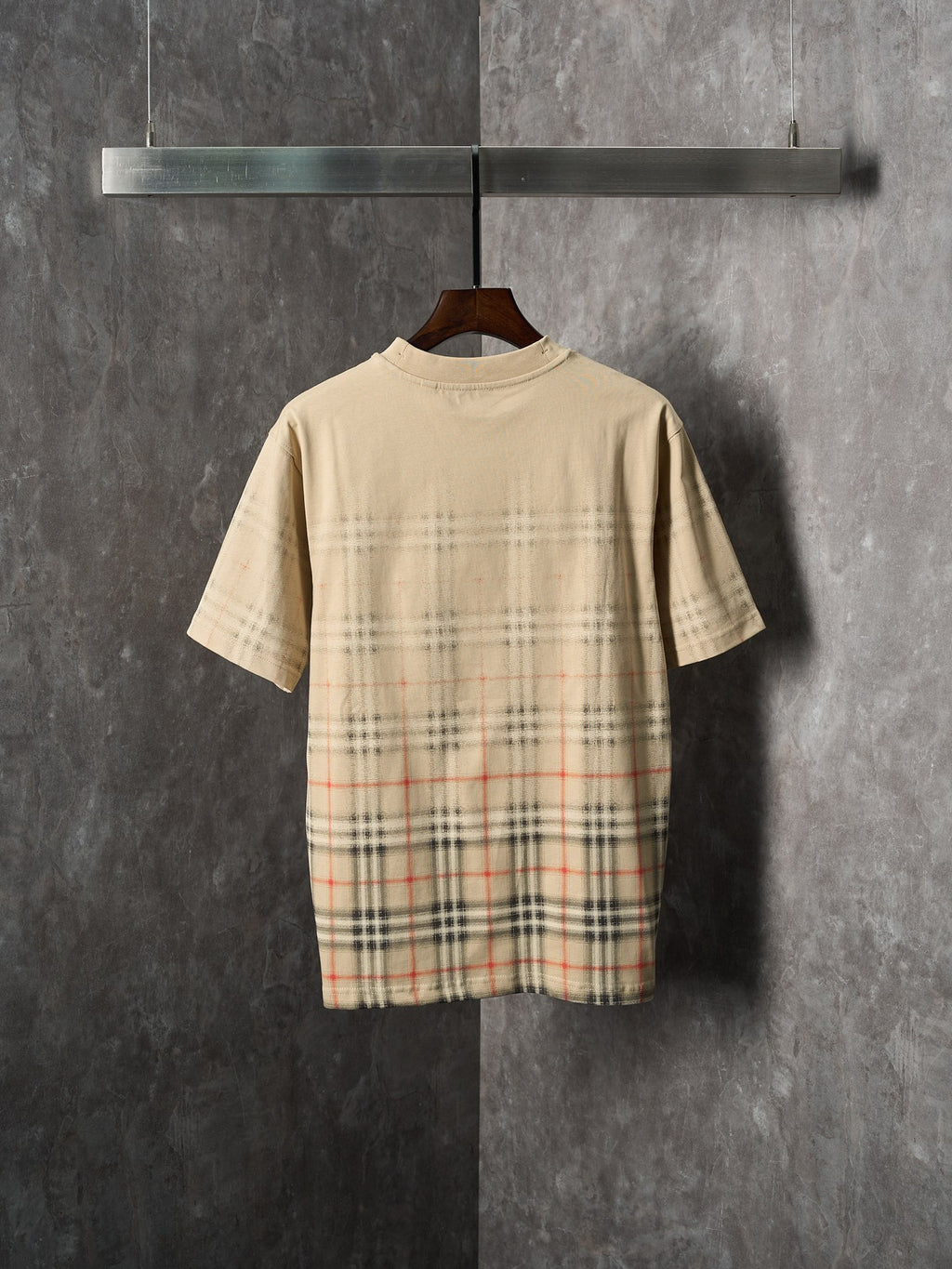 Beige short-sleeve T-shirt with check plaid graphic across the back