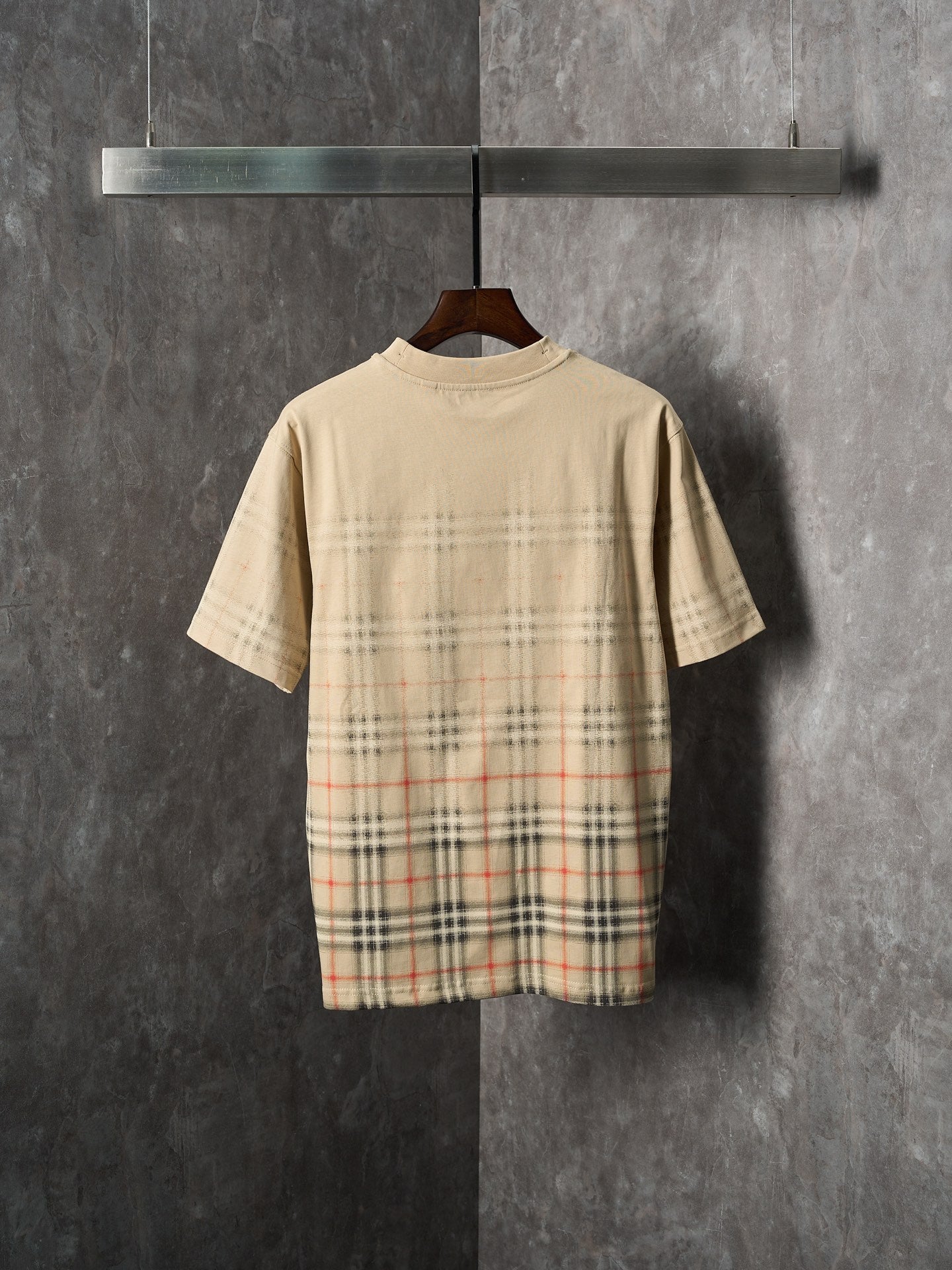 Beige short-sleeve T-shirt with check plaid graphic across the back