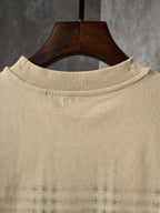 Beige crew-neck short-sleeve T-shirt with check plaid detail near the hem