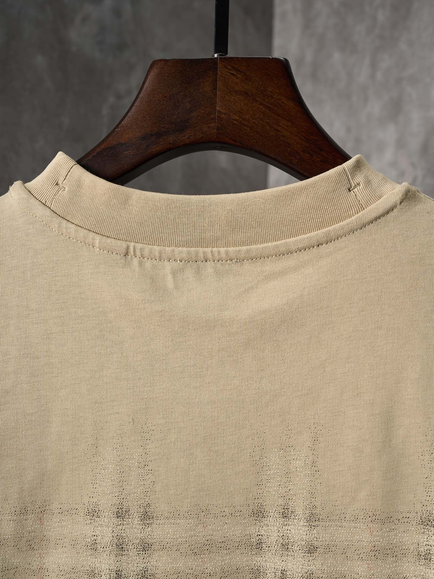 Beige crew-neck short-sleeve T-shirt with check plaid detail near the hem