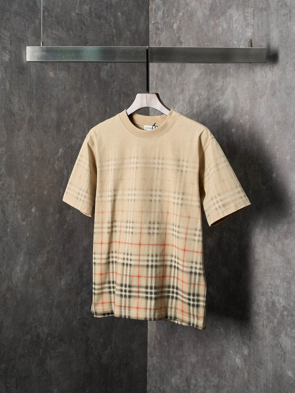 Beige short-sleeve T-shirt with crew neck and check plaid panel at the hem
