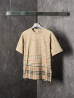 Beige short-sleeve T-shirt with crew neck and check plaid panel at the hem