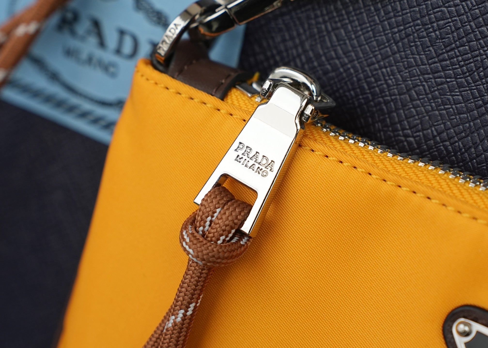 Mustard bag zipper tab with braided pull and leather strap attachment