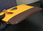 Two-tone clutch bag with brown trim, mustard body, and zipper at the top edge