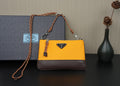 Two-tone mustard and brown crossbody bag with braided shoulder strap and logo plaque
